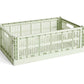 Side-angle view of the large HAY Colour Crate in a fresh mint green, showcasing its high-capacity, stackable, ventilated industrial design made from recycled plastic.