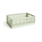 Side-angle view of the large HAY Colour Crate in a fresh mint green, showcasing its high-capacity, stackable, ventilated industrial design made from recycled plastic.