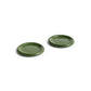 Side angle of two HAY Barro terracotta 18cm plates showcasing a fresh high-gloss green glaze and distinctive natural rolled edges.