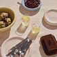 Table setting with Hay Barro collection, glasses, and utensils on a light surface