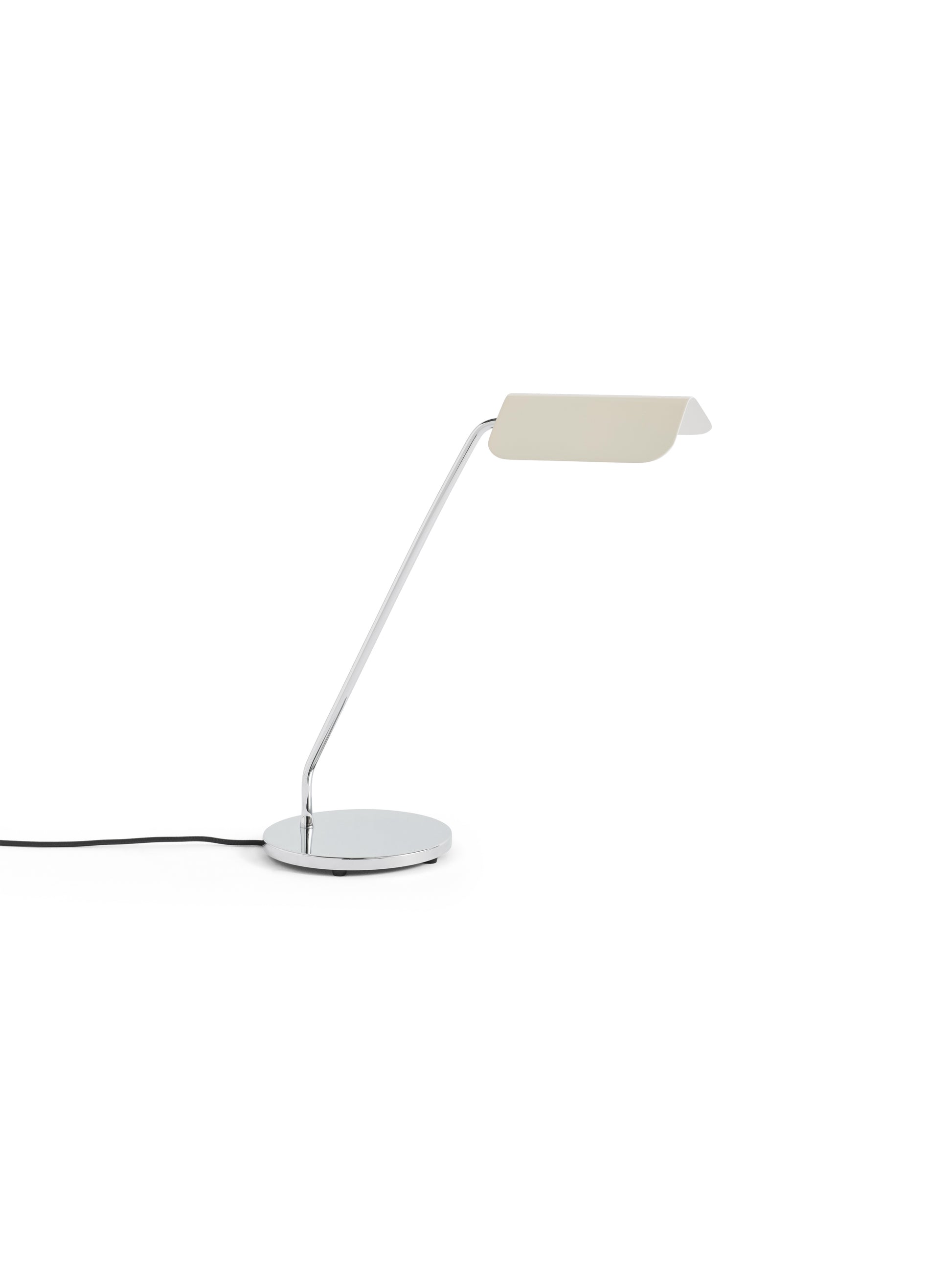 Side-angle view of the HAY Apex Desk Lamp featuring a folded steel shade in soft oyster white, beautifully contrasted against a sleek, chrome-plated angled base.