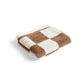 Folded HAY organic cotton wash cloth featuring a classic cappuccino brown and white check pattern, showcasing its soft, absorbent terry texture.