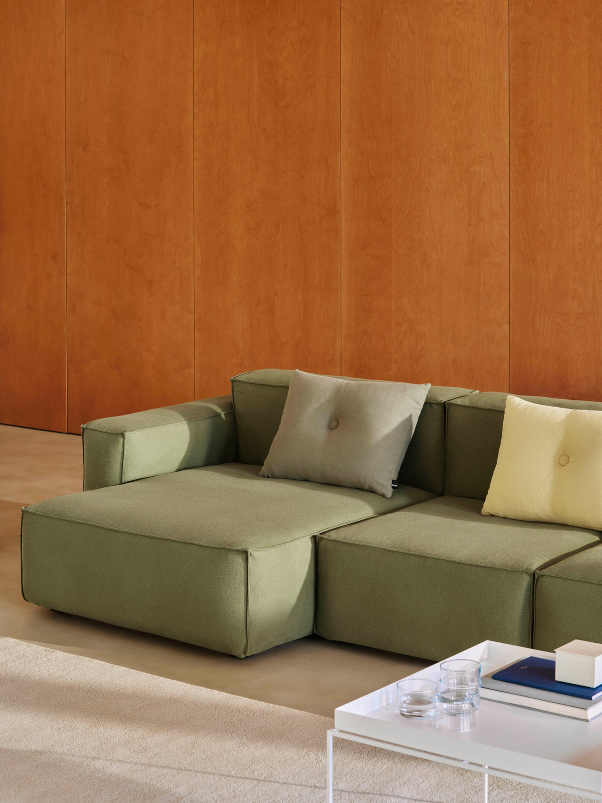HAY Dot Cushions styled on contemporary green sofa.
