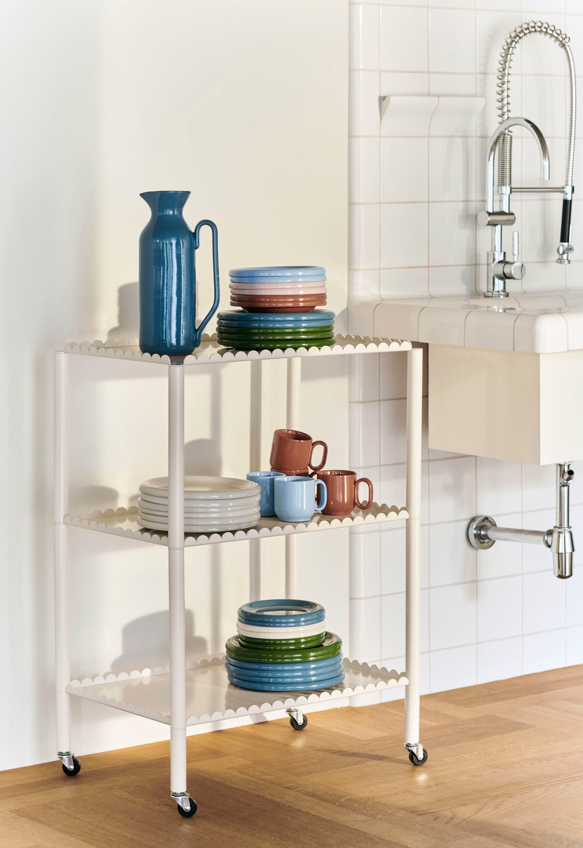 Hay Barro plates staked on a trolly in a kitchen. 