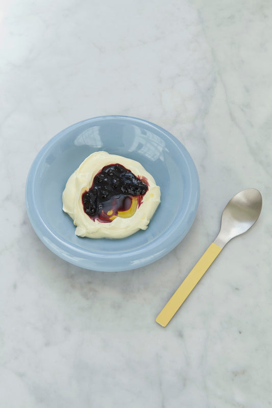 HAY Barro terracotta bowl set of two in high gloss light blue glaze by designer Rui Pereira, paired with HAY yellow spoon.