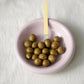 Hay Barro bowl in Pink with green olives on a white table cloth