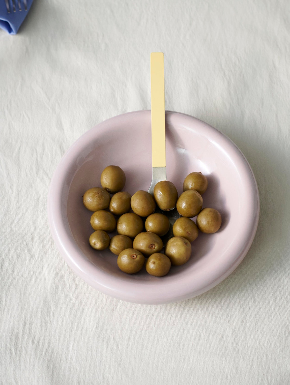 Hay Barro bowl in Pink with green olives on a white table cloth
