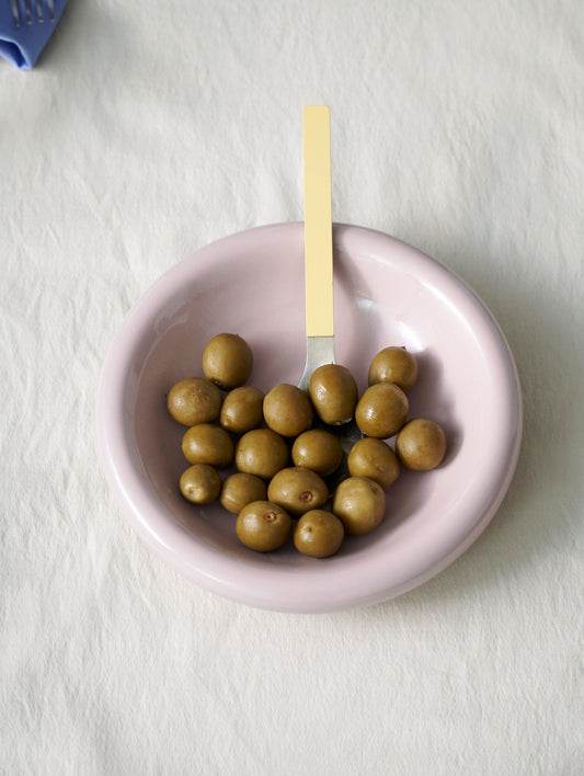 Hay Barro bowl in Pink with green olives on a white table cloth