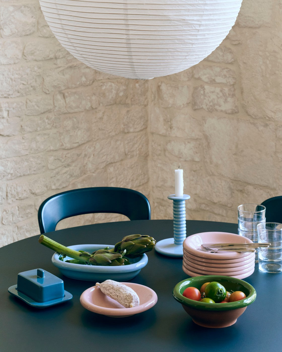 HAY Barro light blue terracotta oval dish on a dinning table, paired with Barro candle holder and butter dish. 