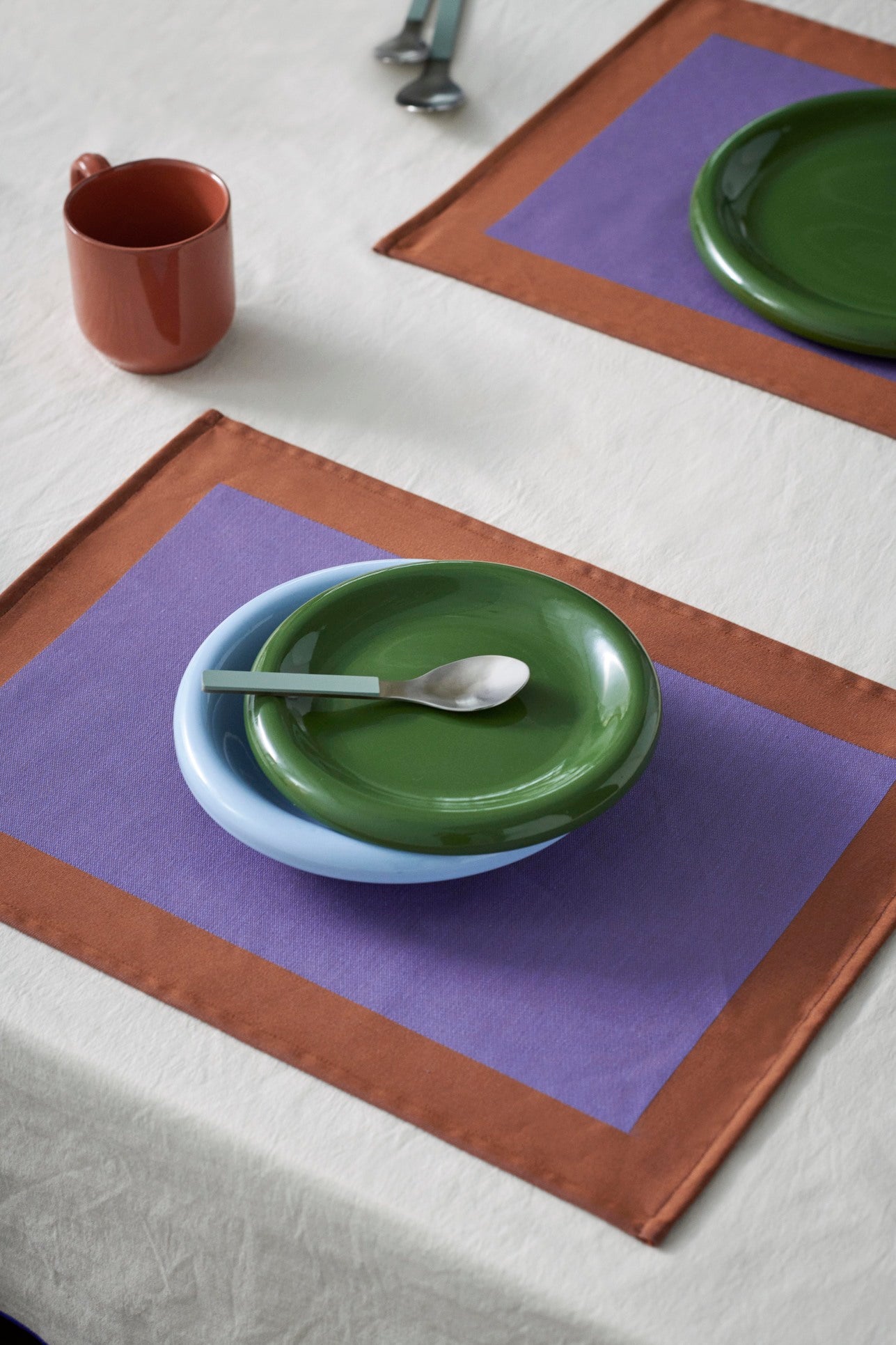 Hay Barro Plate 18cm in Green stacked on ont top Hay Barro Bowl in light blue. 