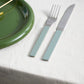 Hay Barro Plate 18cm in Green with a knife and fork on a white tablecloth