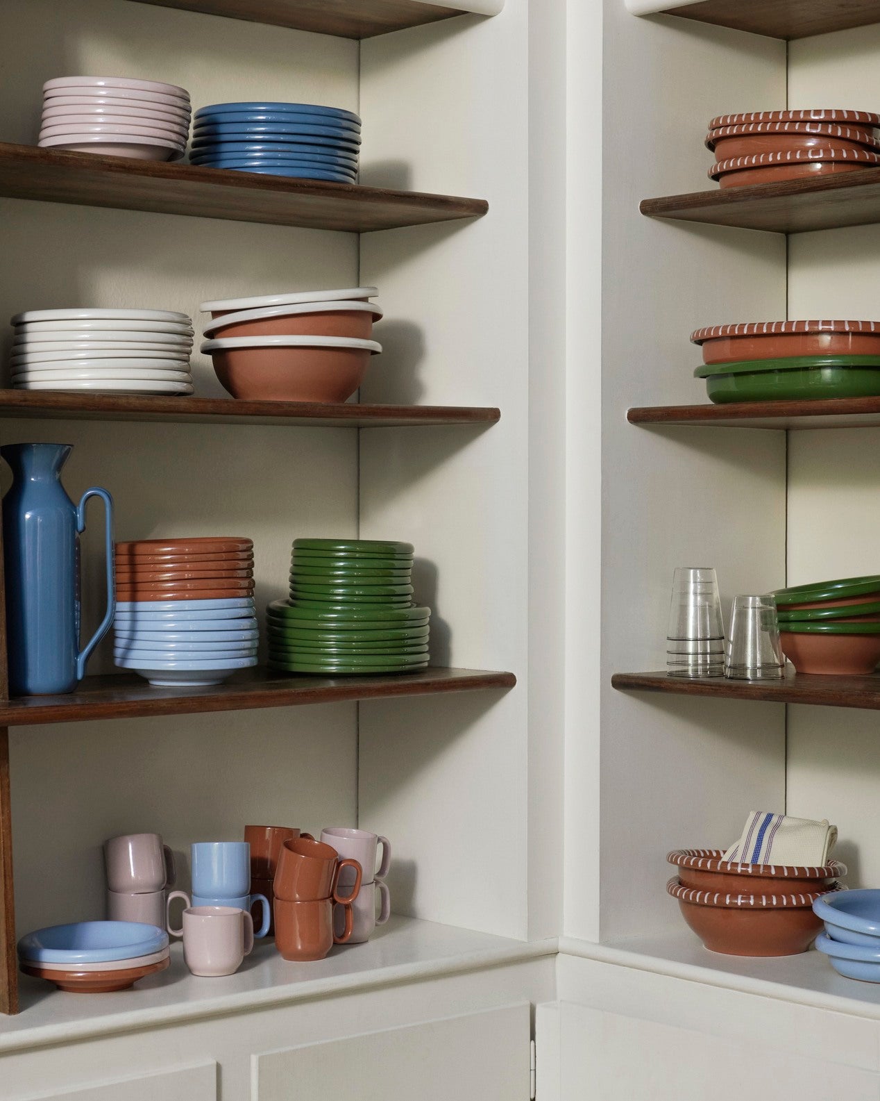 Corner of a homeware shop with wooden shelves displaying various Hay Barro plates.