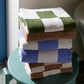 A lifestyle shot of HAY organic cotton wash clothes, available in multiple colours.