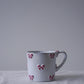 CARRON Paris handmade white ceramic Nœud-Nœud Trianon mug in medium, featuring a hand-painted dusty rose bow detail.