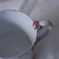 Close up of Carron Paris Noeud Noeud Mug in dusty rose, with a small pink bow decoration on the handle and matching pink bow details around the body.