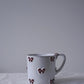 CARRON Paris handmade white ceramic Nœud-Nœud Trianon mug in medium size featuring a hand-painted deep bordeaux bow handle detail
