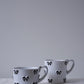 CARRON Paris handmade white ceramic Nœud-Nœud Trianon mug featuring a hand-painted black bow detail, available in small and medium. 