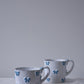 CARRON Paris handmade white ceramic Nœud-Nœud Trianon mug featuring a hand-painted sky blue bow detail, available in small and medium.
