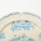 Close-up of hand applied blue rose copperplate transfer and carved relief rim on Studio M plate