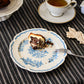 Studio M La Paix Rose floral ceramic plate served with slice of cake at afternoon tea