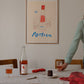A lifestyle photo of the rrt print Poetica by Das Rotes Rabbit exclusively created for The Poster Club, in a light wooden frame.