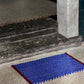 A lifestyle shot of the HAY Door Mat in Royal Blue. 