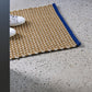 A lifestyle photo of the Hay door mat in yellow.