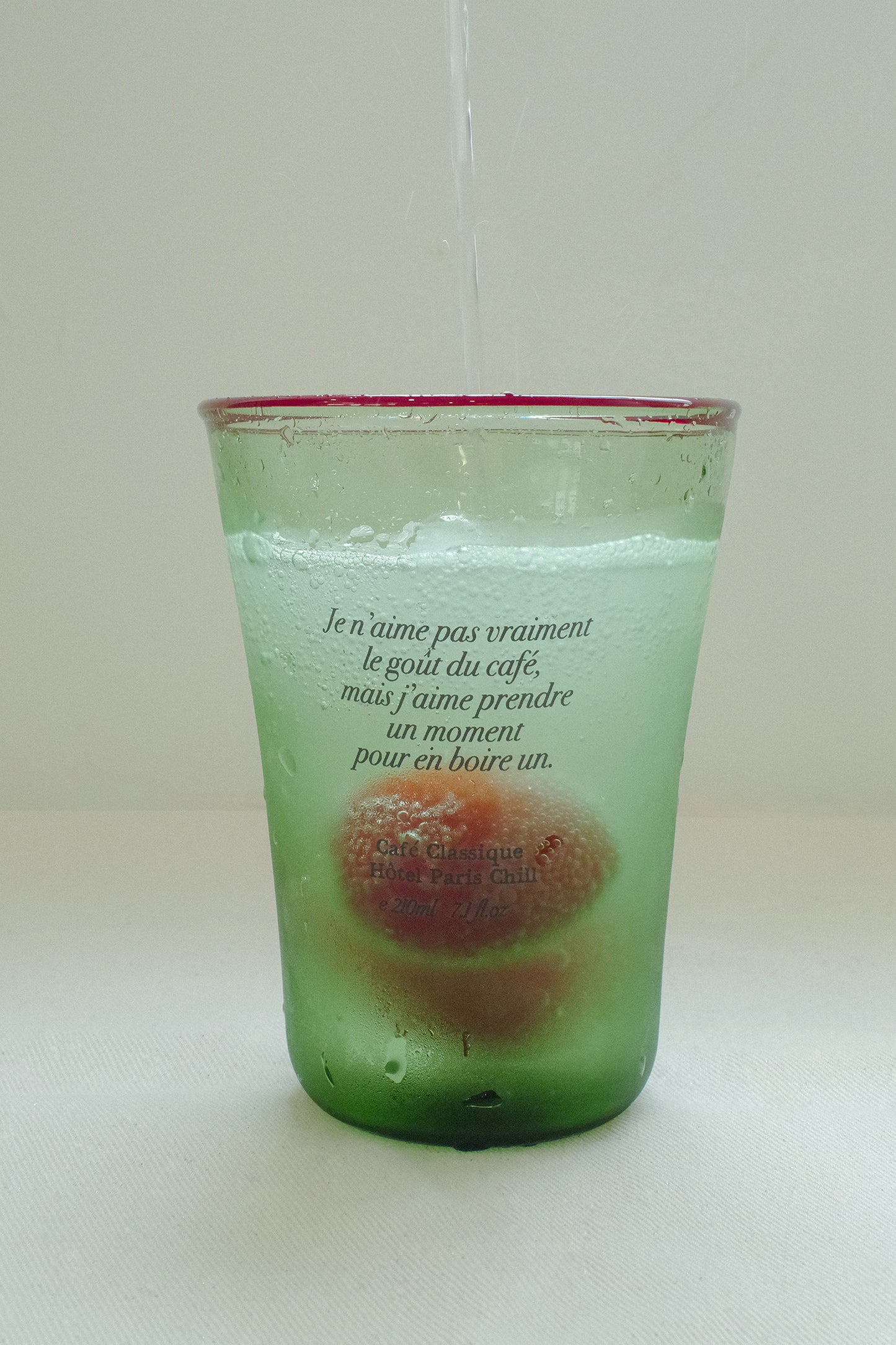 Iced drink served in HÔTEL827 Olive green tinted glassware.