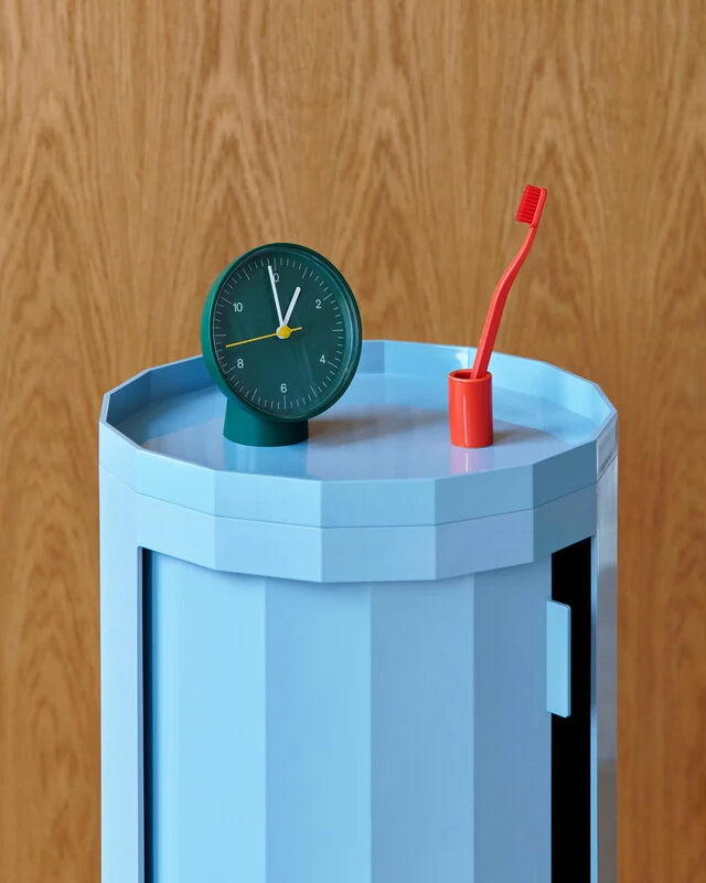 HAY Tann toothbrush red in toothbrush holder on a blue side table.