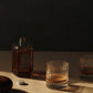 Whiskey served in ferm LIVING Ripple clear glass tumbler on kitchen benchtop.