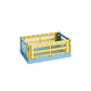 Side-angle view of the small HAY Colour Crate Mix in a muted dusty yellow, showcasing its stackable, ventilated industrial design made from recycled plastic.