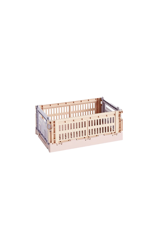 Side-angle view of the small HAY Colour Crate in a soft powder hue, showcasing its stackable, ventilated industrial design made from recycled plastic.