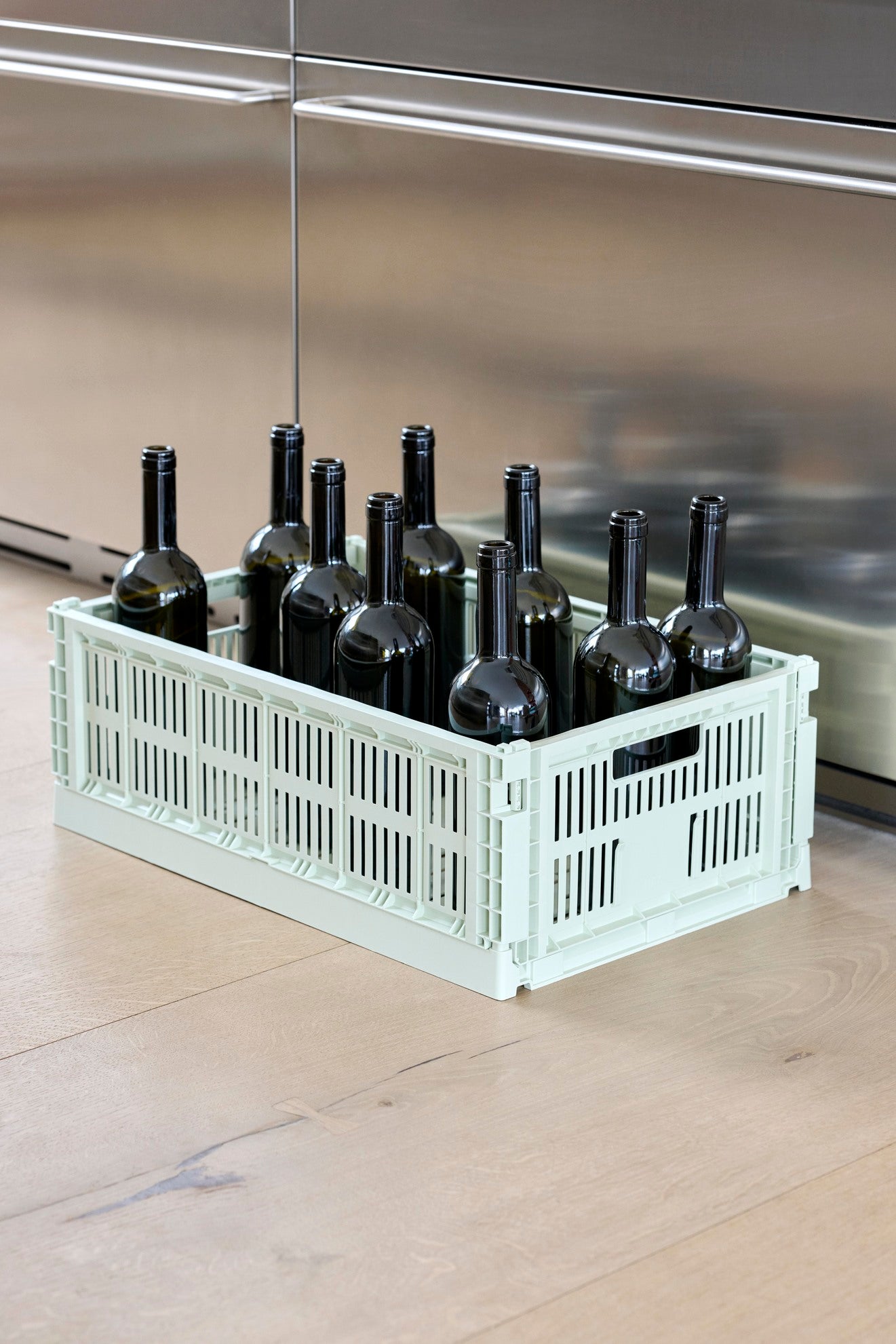Hay Large Colour Crate in mint, storing wine bottles. 