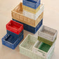 Stack of colorful Hay Colour Crates on the floor.