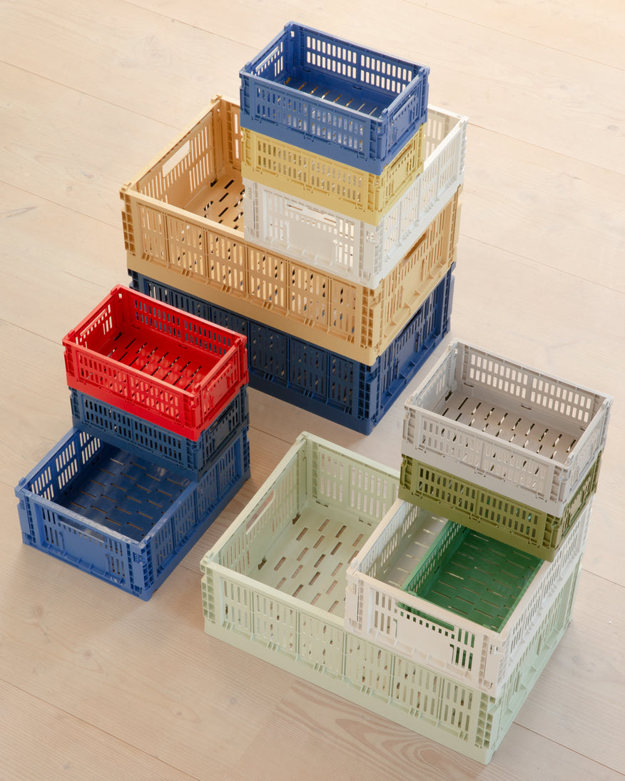 Stack of colorful Hay Colour Crates on the floor.