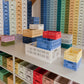Stacked Hay Colour Crate organisers in a shop. 