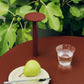 Hay barro plate 18cm in off-white on a red side table with a water glass. 