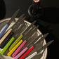 Opinel N125 table knives in assorted colorful wooden handles, placed on Tuxton oval platter.