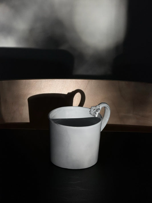 Sunlit Carron Paris ceramic mug with a unique sculpted flower on the handle