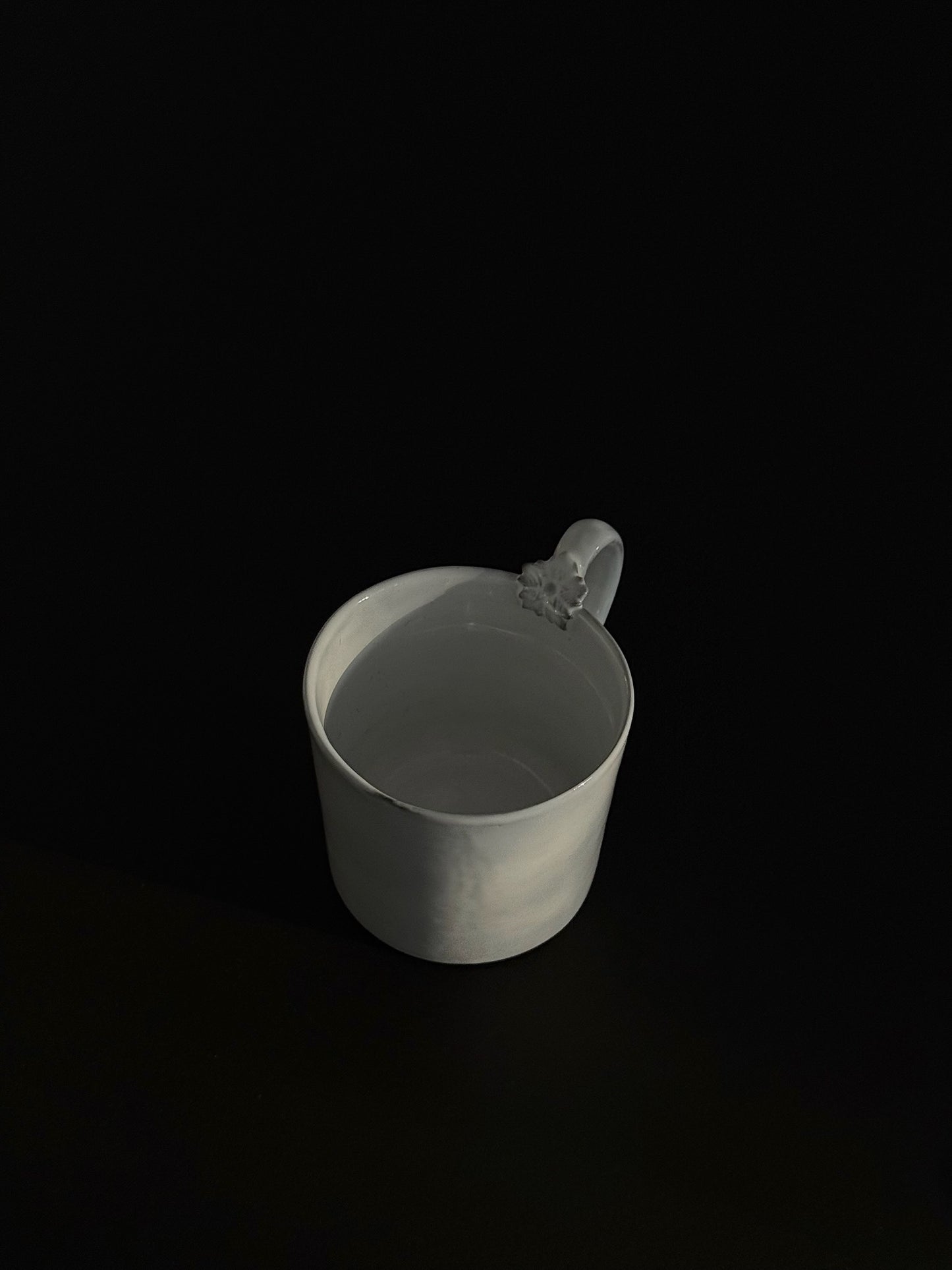 A zoom-out shot of Carron Paris ceramic mug with a unique sculpted flower on the handle