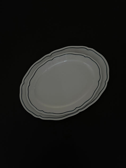 Tuxton Charleston oval serving platter in American White with embossed scalloped edges, available in two sizes. 