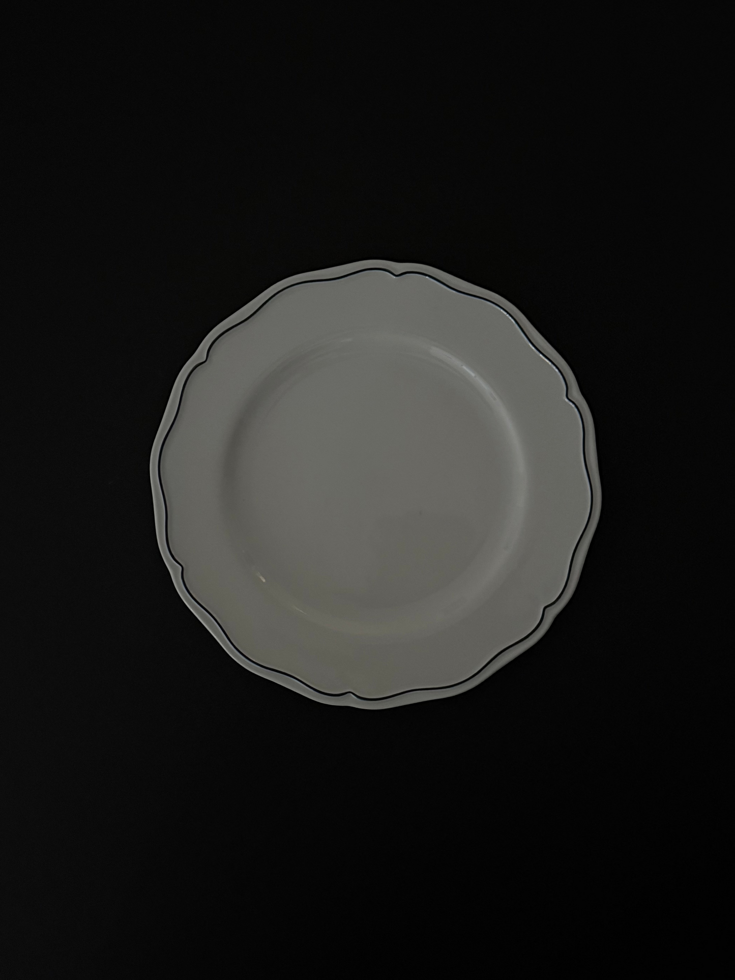 Tuxton Charleston round dinner plate in American White with embossed scalloped edges.