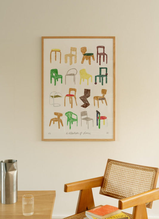 A lifestyle photo of Art print A Collection of Chairs by Isabelle Vandeplassche, exclusively for The Poster Club, in a light wooden frame.