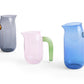 Side-angle view of the collection of HAY borosilicate glass jug designed by Jochen Holz. 
