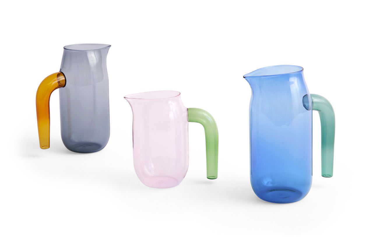 Side-angle view of the collection of HAY borosilicate glass jug designed by Jochen Holz. 