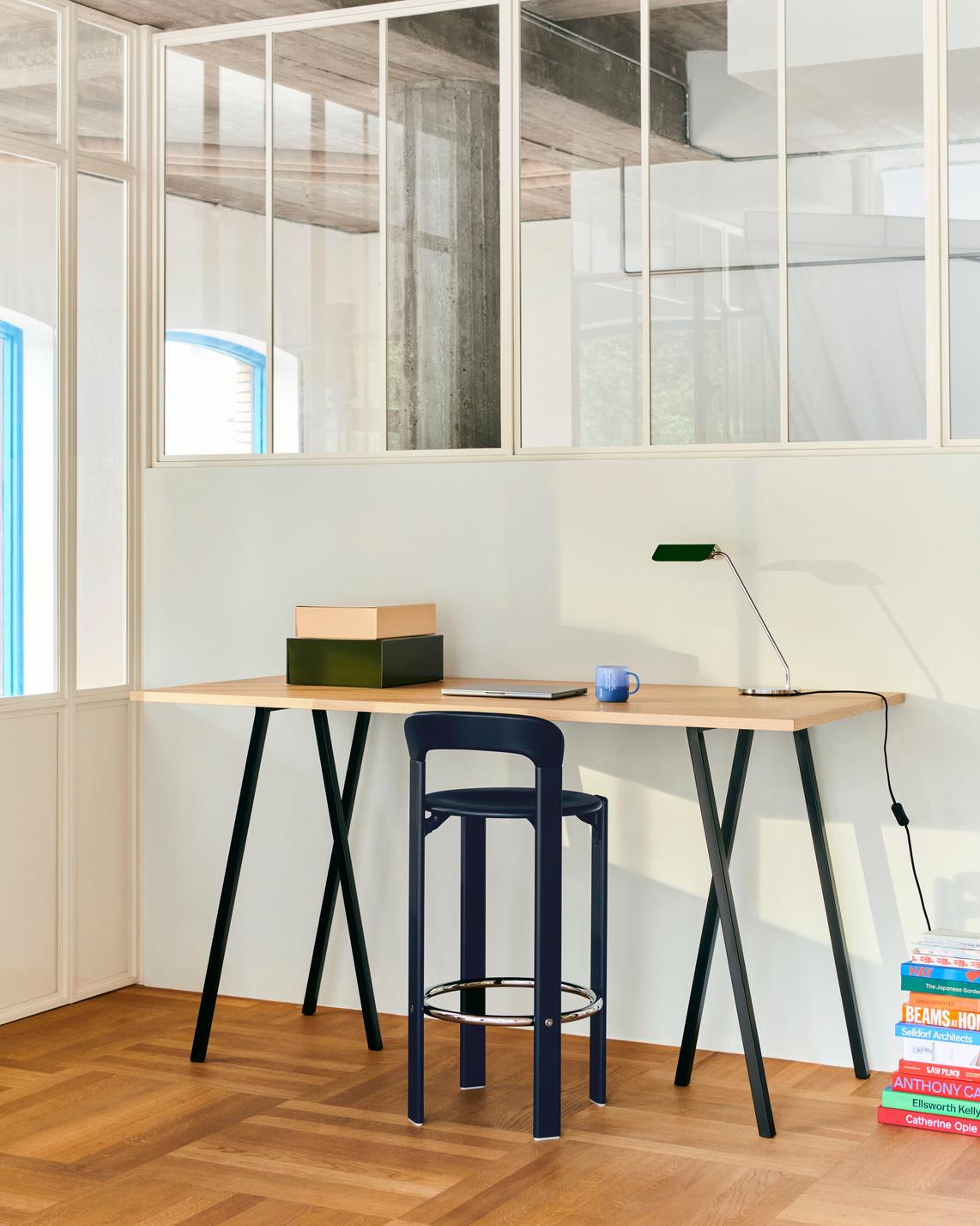 Modern office setup with Hay Apex desk lamp in Emerald Green on a wooden desk.