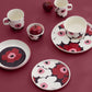 Marimekko Oiva collection from Fall Winter 2026 featured on a cranberry table setting. 