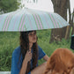 Woman holding HÔTEL827 Lilac Overhaze sun parasol umbrella on a sunny day