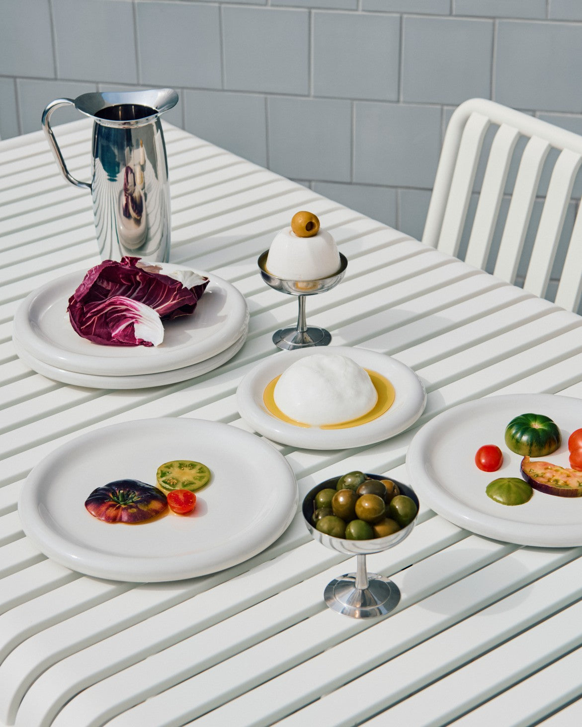 Table setting with a variety of Hay Barro tableware in off-white. 