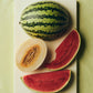Hay slice chopping board in Ice Lime with chopped melons. 